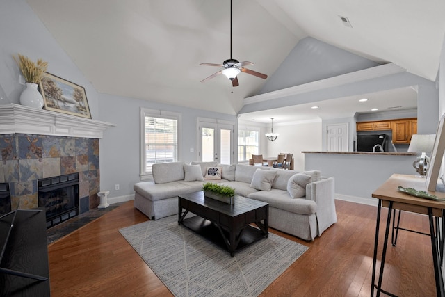 living room featuring ceiling fan, dark hardwood / wood-style floors, and high vaulted ceiling