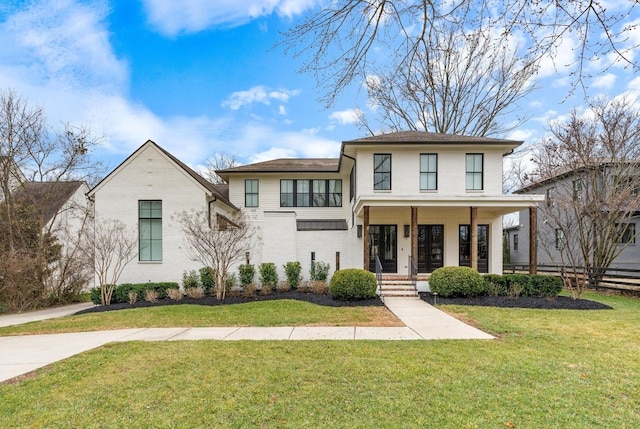 view of front of property featuring covered porch and a front lawn