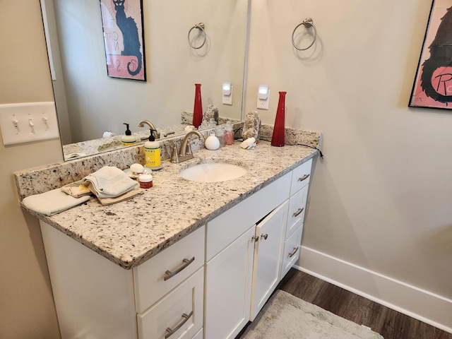 bathroom with vanity and hardwood / wood-style flooring