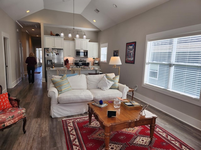 living room with dark hardwood / wood-style flooring and high vaulted ceiling