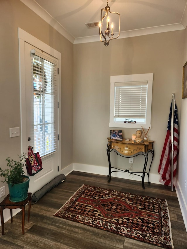 interior space featuring crown molding, dark wood-type flooring, and an inviting chandelier