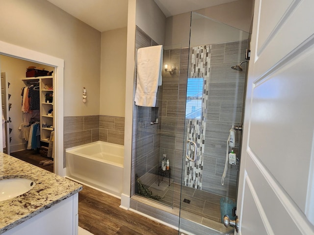 bathroom featuring vanity, hardwood / wood-style floors, and independent shower and bath