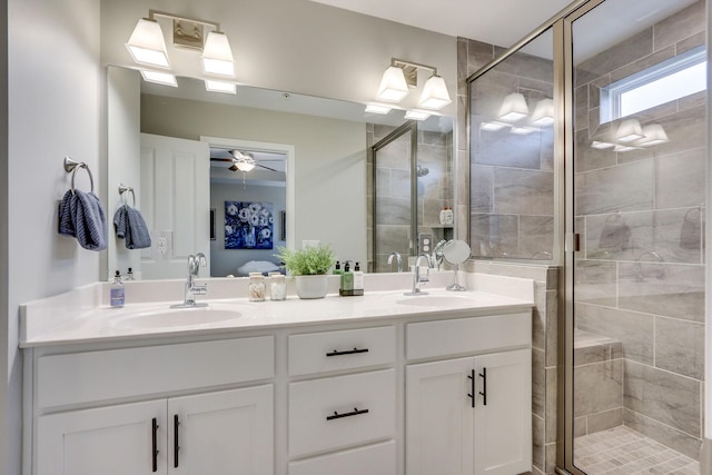 bathroom with ceiling fan, vanity, and a shower with door