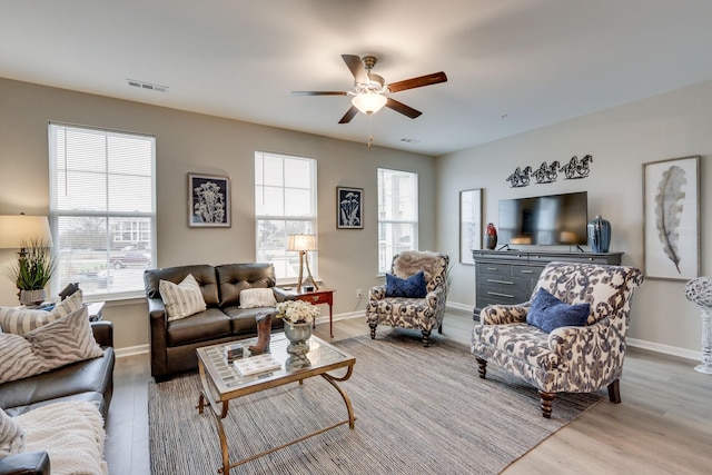 living room featuring ceiling fan and light wood-type flooring