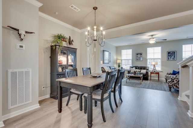 dining space featuring crown molding, light hardwood / wood-style flooring, and plenty of natural light