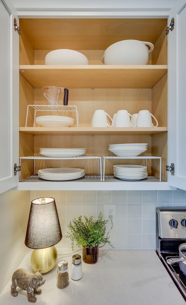 room details featuring stainless steel electric range oven and decorative backsplash