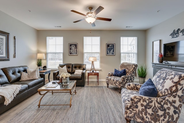 living room featuring ceiling fan and light hardwood / wood-style floors