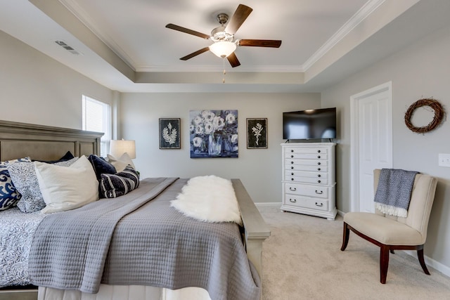 bedroom featuring ornamental molding, light colored carpet, a raised ceiling, and ceiling fan