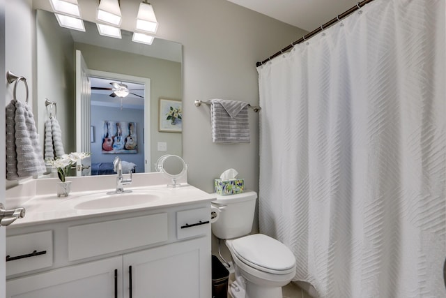 bathroom with vanity, toilet, and curtained shower