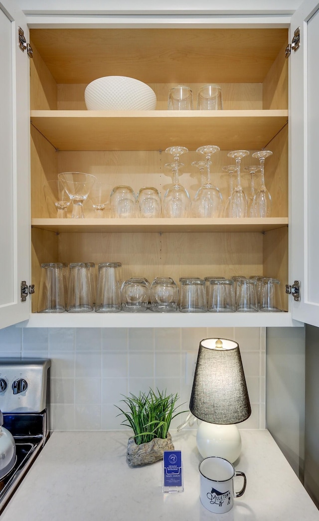 details with decorative backsplash and electric range