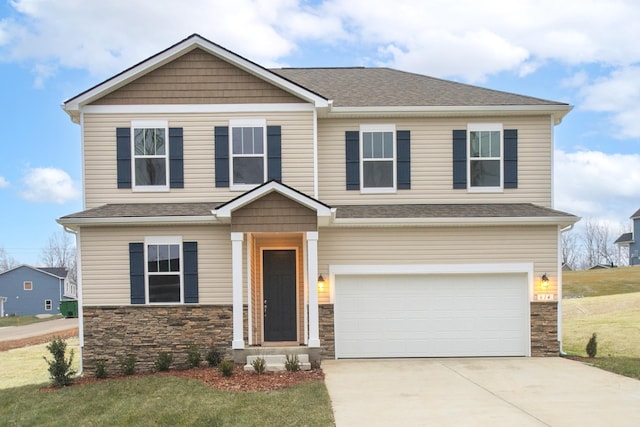 craftsman inspired home featuring a garage and a front lawn