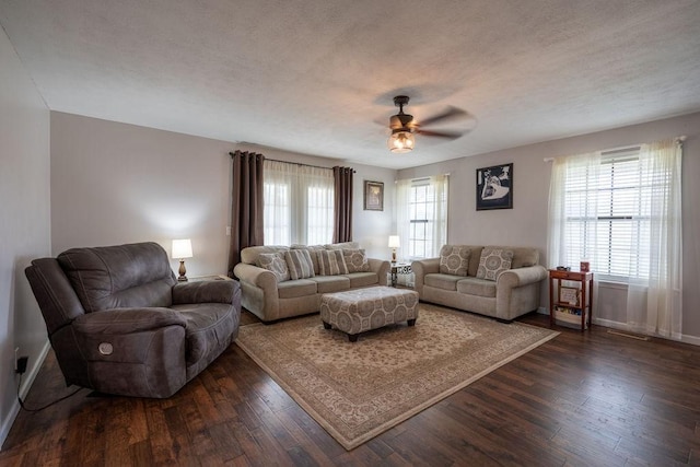 living room with ceiling fan, a wealth of natural light, a textured ceiling, and dark hardwood / wood-style flooring