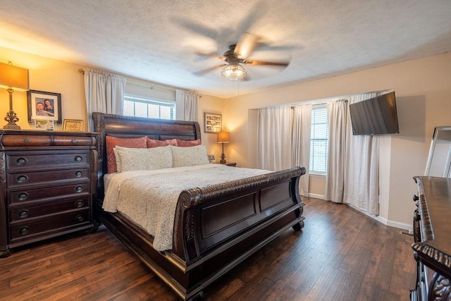 bedroom featuring ceiling fan, dark wood-type flooring, and a textured ceiling