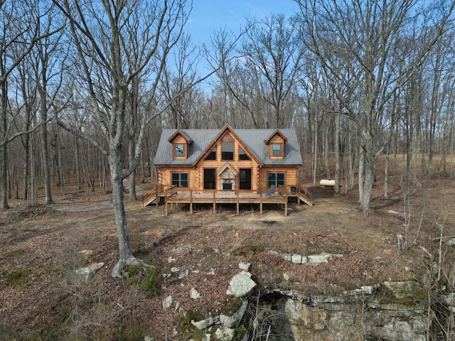 rear view of property with a wooden deck