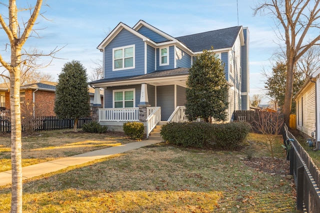 view of front of property featuring covered porch and a front lawn