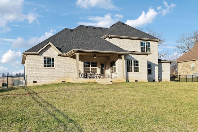 rear view of property featuring a yard, a patio area, and ceiling fan