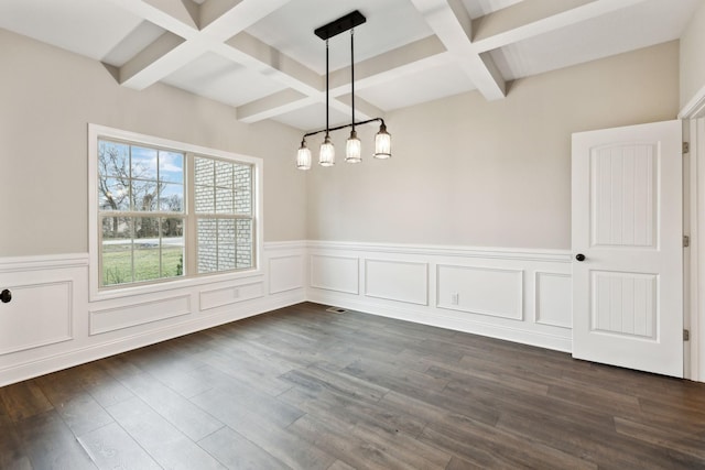 unfurnished dining area with coffered ceiling, dark wood-type flooring, and beam ceiling