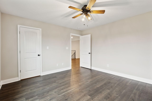 unfurnished bedroom featuring dark hardwood / wood-style floors and ceiling fan