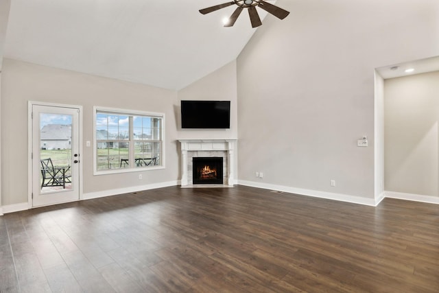 unfurnished living room with ceiling fan, high vaulted ceiling, and dark hardwood / wood-style flooring