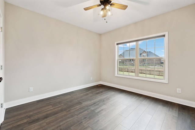 spare room featuring ceiling fan and dark hardwood / wood-style flooring