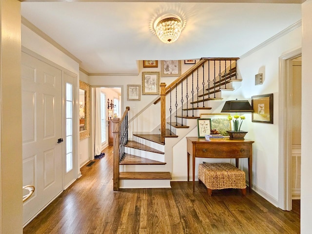 entrance foyer featuring ornamental molding and dark wood-type flooring