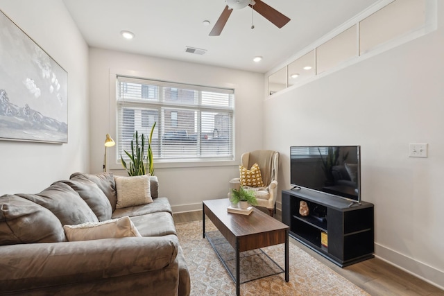 living room with ceiling fan and light wood-type flooring