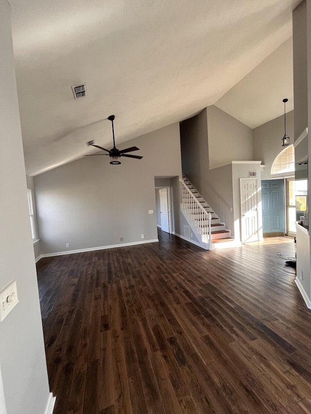 unfurnished living room featuring dark wood-style flooring, visible vents, stairway, ceiling fan, and baseboards