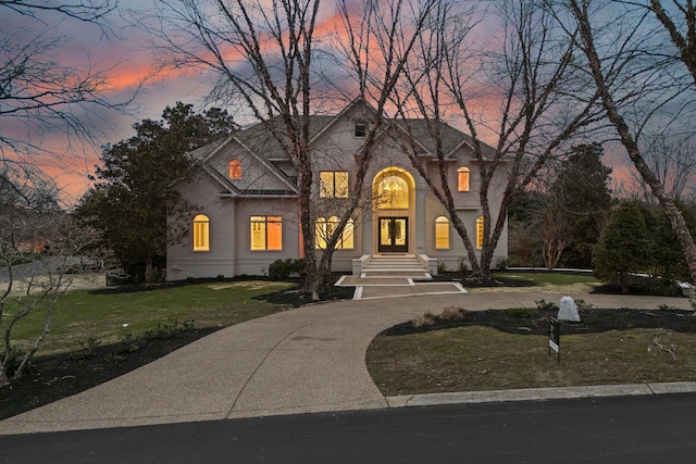 french country home featuring a yard