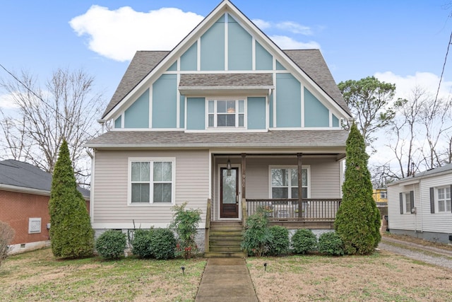 tudor house with a porch and a front yard