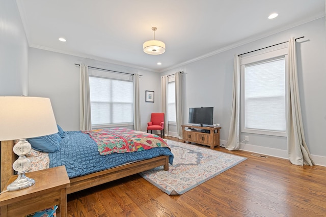 bedroom featuring wood-type flooring and ornamental molding