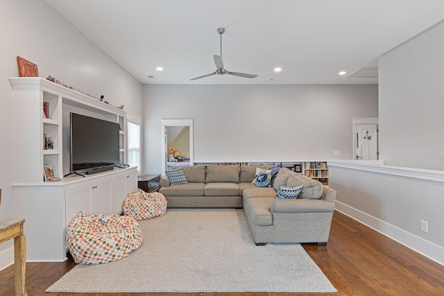 living room with dark wood-type flooring and ceiling fan