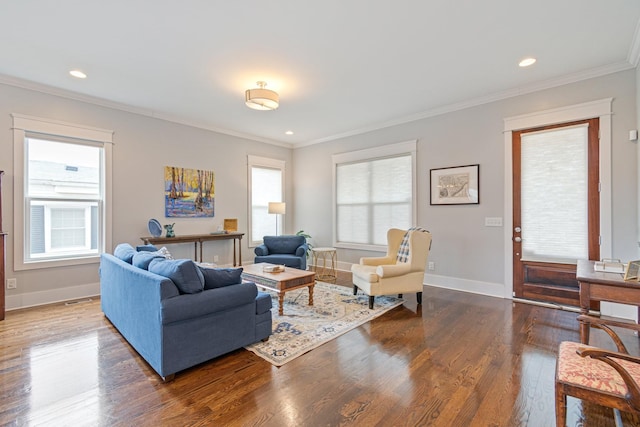 living room featuring hardwood / wood-style flooring, ornamental molding, and plenty of natural light