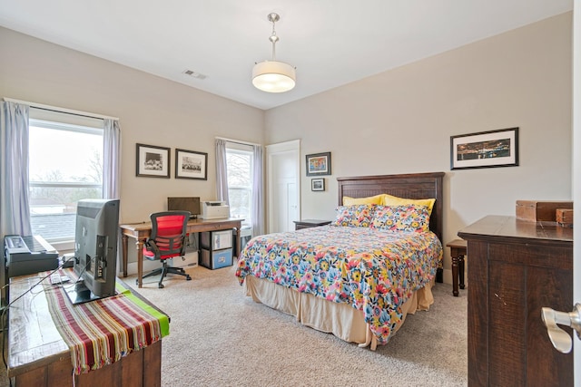 carpeted bedroom featuring multiple windows