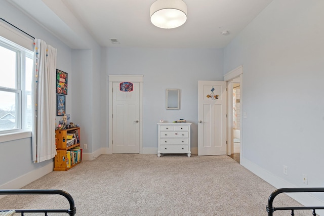 living area featuring light carpet