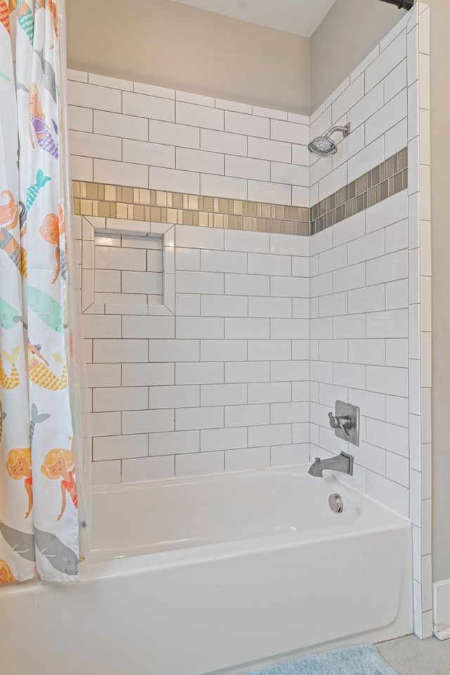 bathroom with shower / bath combo with shower curtain