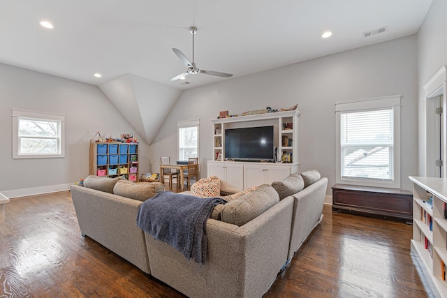 living room with plenty of natural light and dark hardwood / wood-style flooring