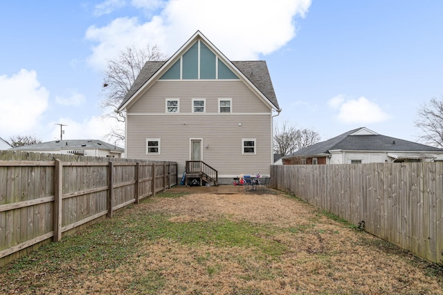 rear view of house with a lawn