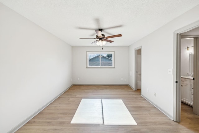 unfurnished bedroom with ceiling fan, light hardwood / wood-style flooring, and a textured ceiling