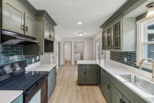 kitchen featuring sink, gray cabinetry, black range with electric stovetop, washer and clothes dryer, and light hardwood / wood-style floors