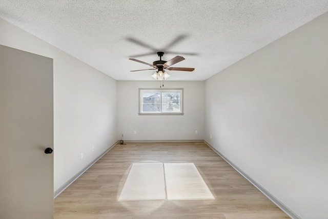 spare room featuring ceiling fan, light hardwood / wood-style flooring, and a textured ceiling