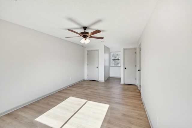 empty room featuring ceiling fan and light wood-type flooring