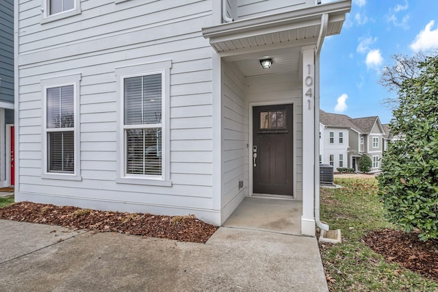 view of exterior entry with central AC unit