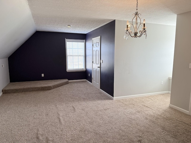 additional living space with lofted ceiling, a chandelier, a textured ceiling, and carpet flooring