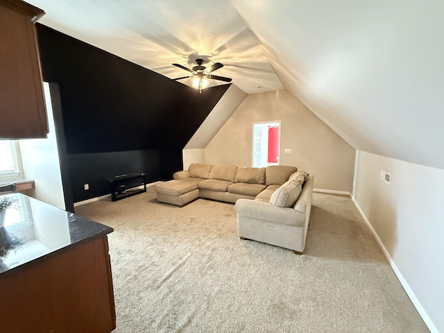 carpeted living room featuring lofted ceiling and ceiling fan