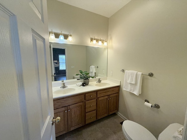 bathroom with vanity, tile patterned flooring, and toilet