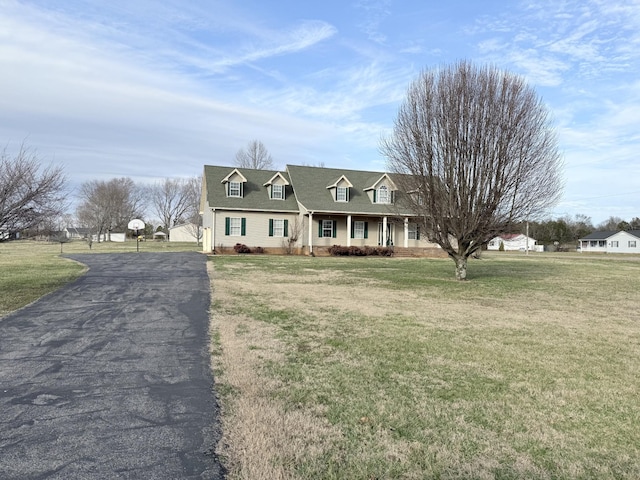 new england style home with a front yard