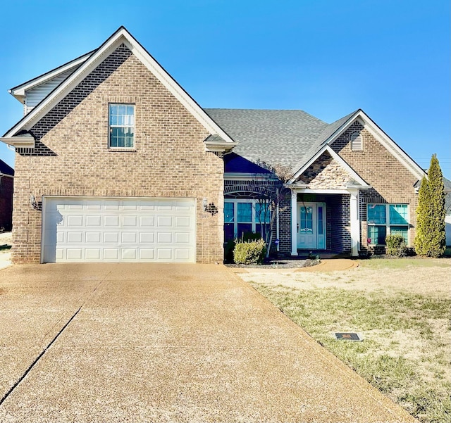 view of front facade featuring a garage and a front lawn