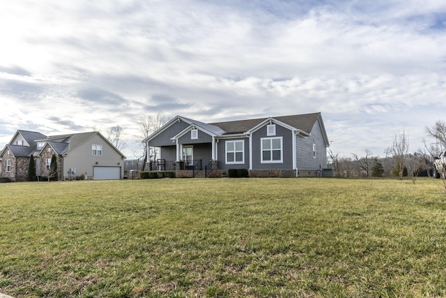 view of front of home with a garage, covered porch, and a front lawn