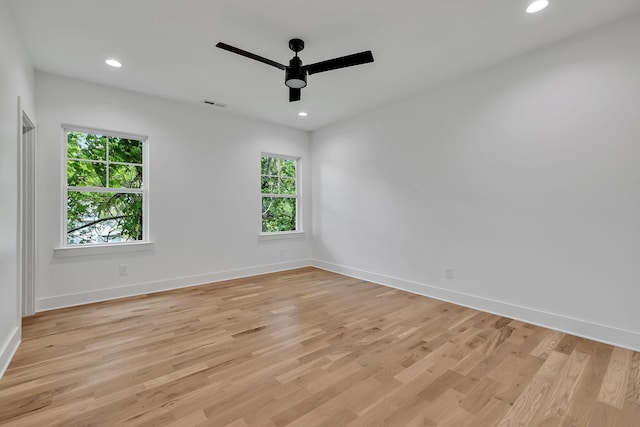 spare room featuring ceiling fan, plenty of natural light, and light hardwood / wood-style flooring