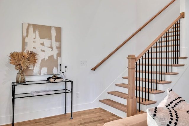 staircase with wood-type flooring